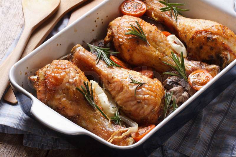Chicken legs with rosemary in a baking dish close-up on the table. horizontal , stock photo