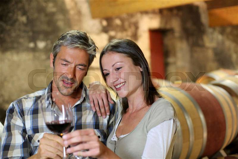 Couple of winemakers tasting red wine, stock photo