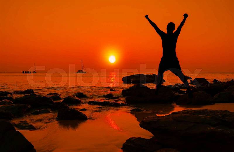 Happy jump during sunset at the beach, stock photo