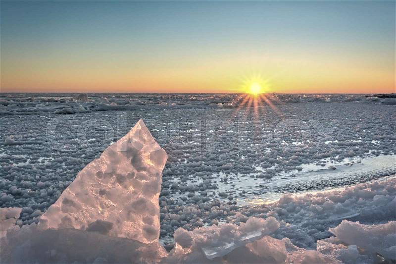 Lake Erie sunrise. Seen here in winter frozen with chunks of broken ice, stock photo