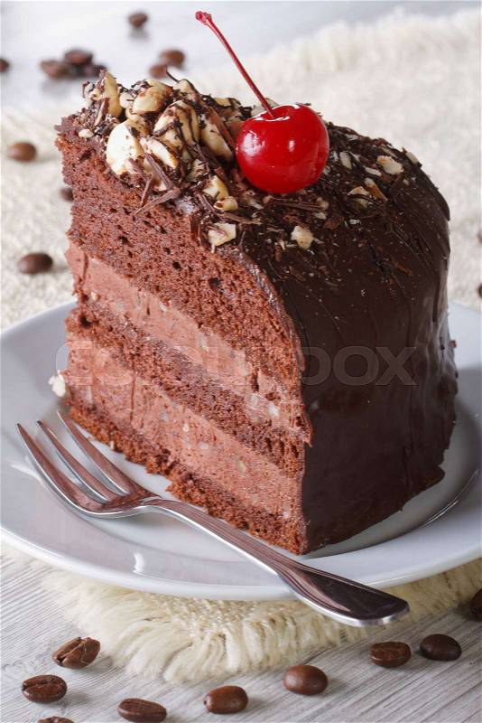 Delicious piece of dark chocolate cake with cherry closeup. vertical\, stock photo