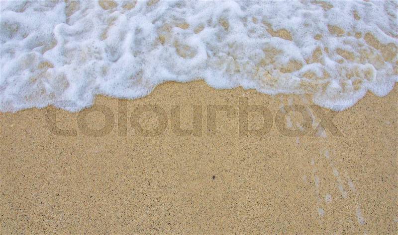 Bubble wave of sea on the sandy beach, stock photo