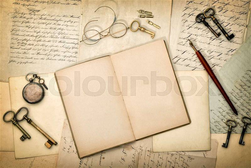 Open diary book, vintage accessories, old letters and postcards. Paper textured background, stock photo