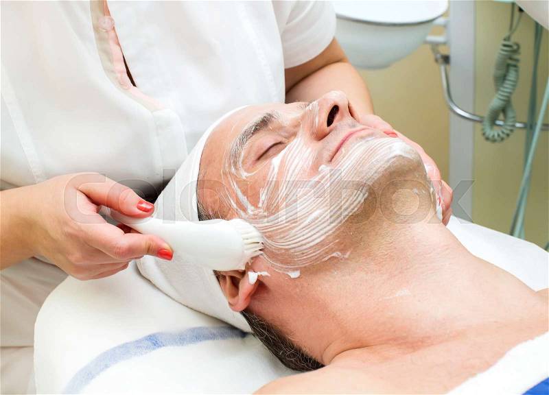 Man in a beauty salon facial and massage, stock photo