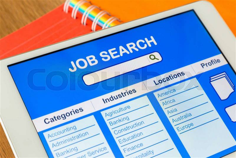 Digital tablet pc showing user interface of online job search on display screen, colorful diary book on background, stock photo