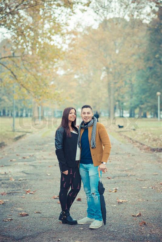 Young couple in the park during autumn season outdoor - lovers valentine , stock photo