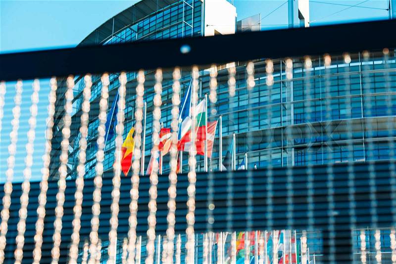 European Parlaiment and all Flags of European Countries seen through chainlink fence, stock photo