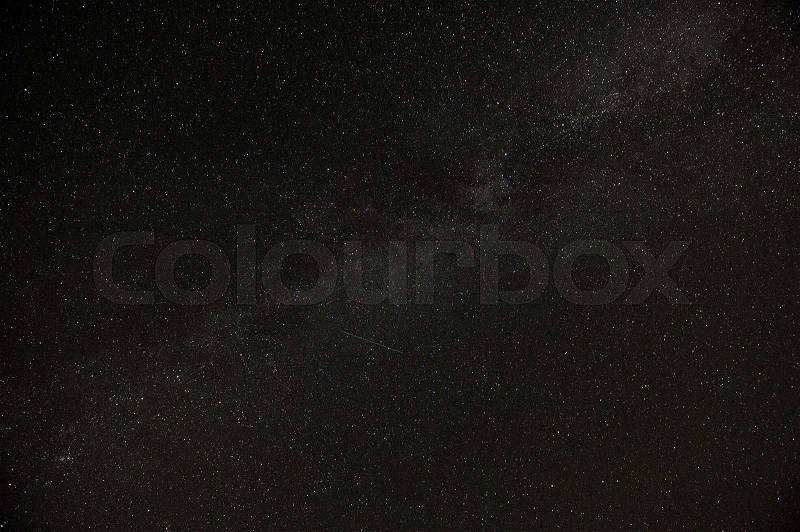 A real dark night sky with plenty of stars and flying satellites, stock photo