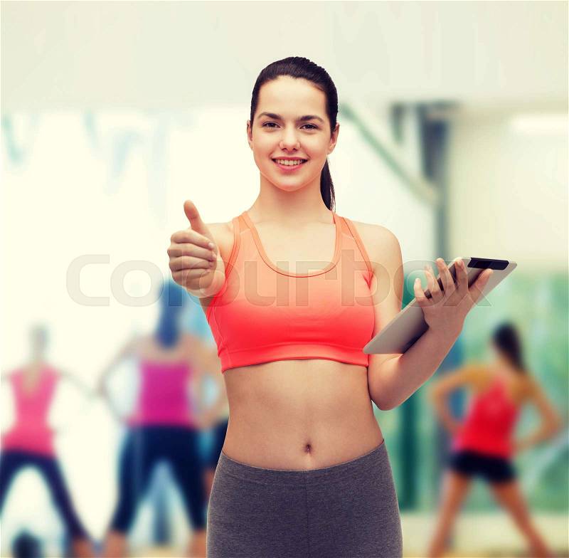 Sport, exercise, technology, internet and healthcare - sporty woman with tablet pc computer showing thumbs up, stock photo