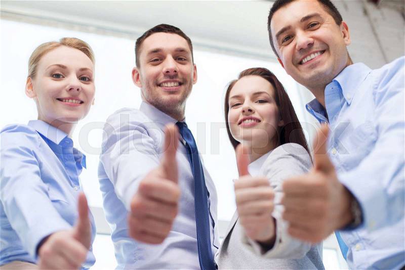 Business, teamwork, success, people and gesture concept - smiling business team showing thumbs up in office, stock photo