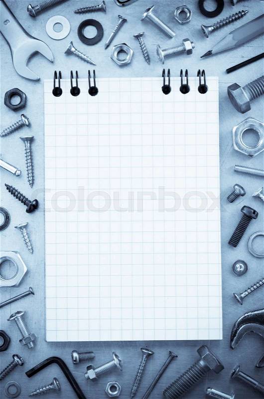 Hardware tools and notebook at metal background texture, stock photo