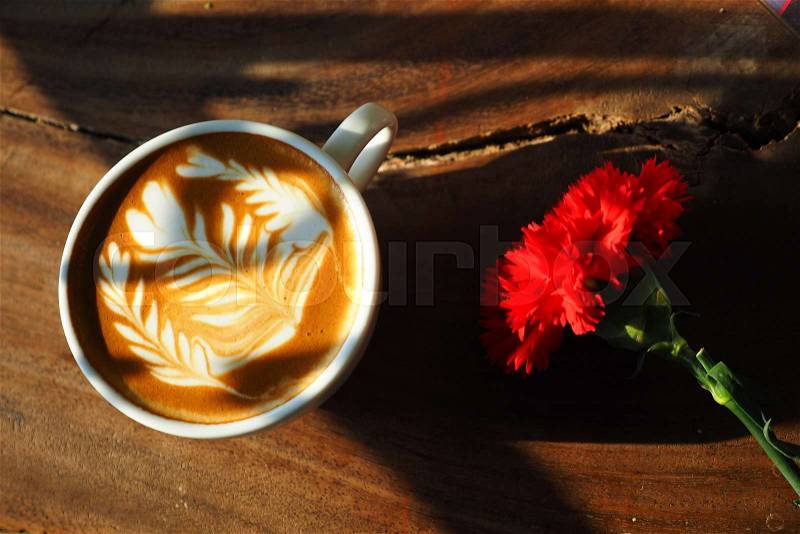 Cup of coffee latte art on the wood background in vintage color style, stock photo