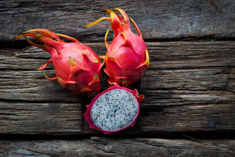 Asian Dragon fruit on the wooden background, stock photo