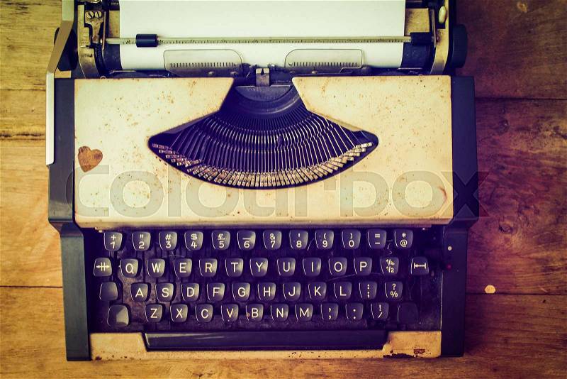 Vintage typewriter and telephone , notebook on the wood desk in vintage color tone, stock photo