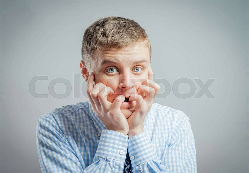 Emotional man keep his mouth closed by his hands, stock photo