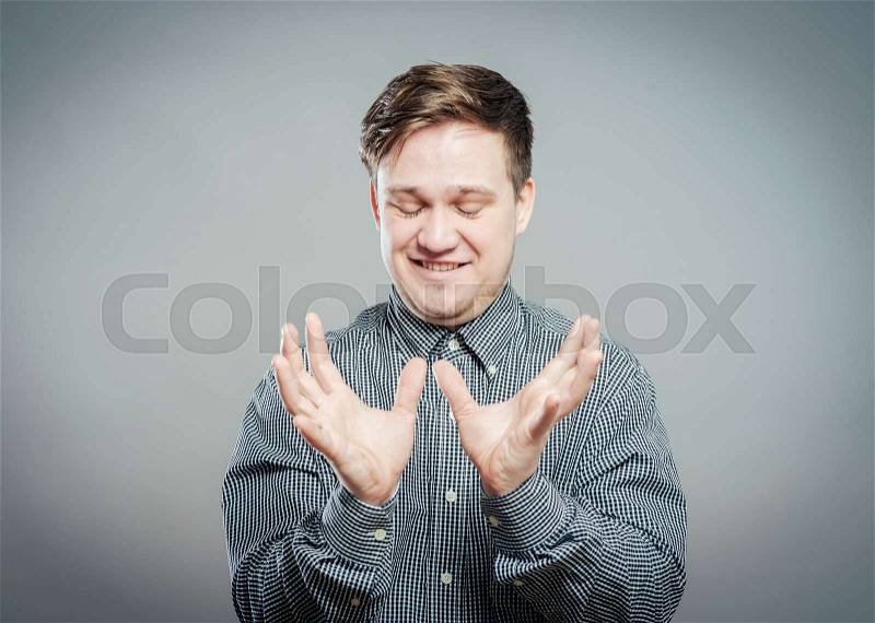 Young man looking shocked and surprised in full disbelief hands up in air, stock photo
