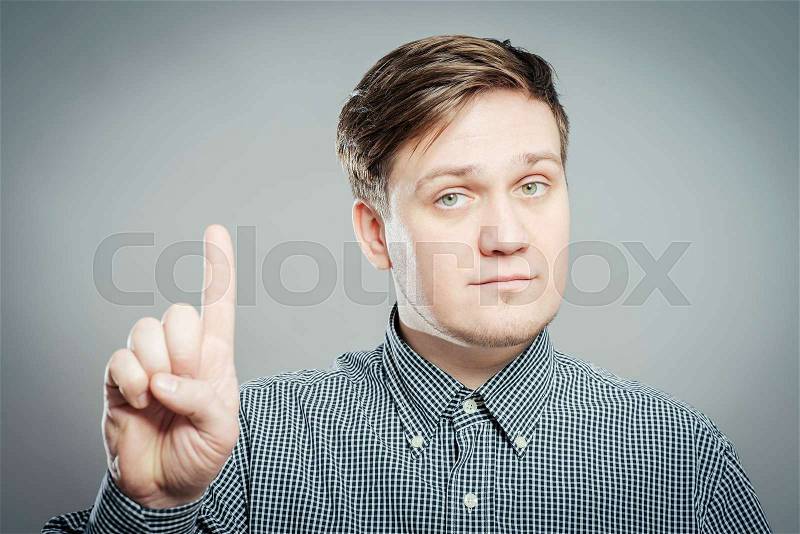 Man pointing up with his index finger, stock photo