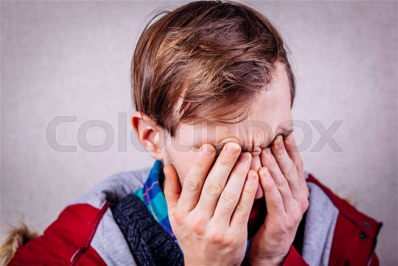 Tired worker rubbing his eyes, stock photo