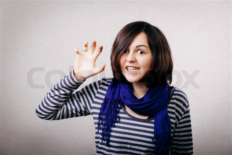 Young fashion woman wants to claw you with an beastly look on her face. , stock photo