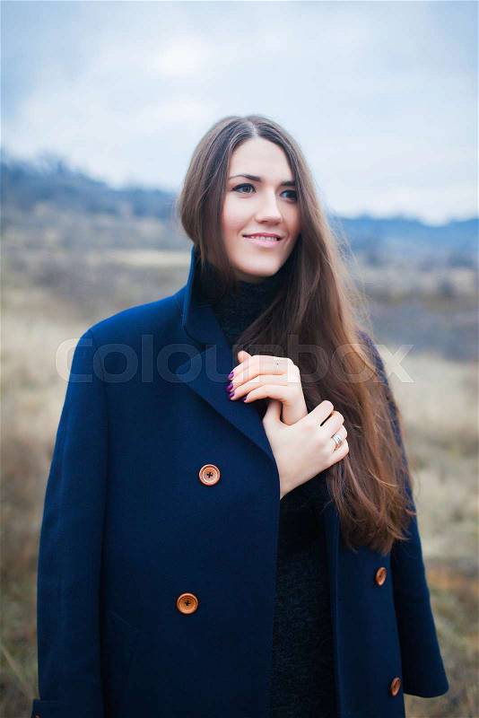 Outdoor winter closeup colorful portrait of young happy brunette. Girl in winter coat , stock photo