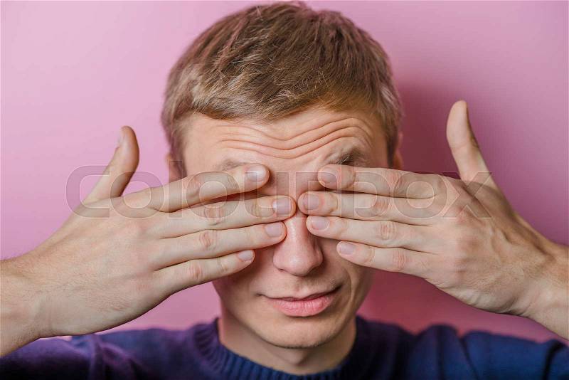 Young man in showing fatigue, sleepy, sleepy, closes his eyes with his hands. gesture. photo shoot, stock photo
