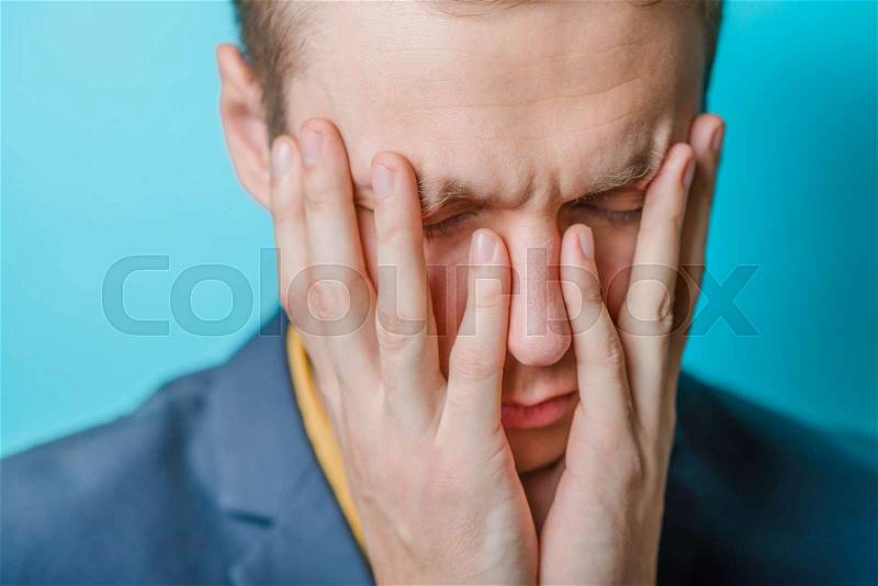 Businessman with big headache touching head , stock photo