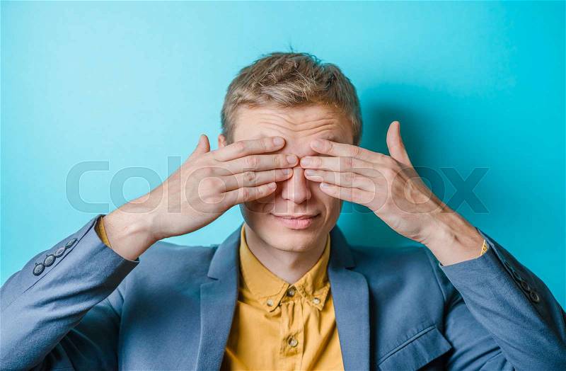 Young man in showing fatigue, sleepy, sleepy, closes his eyes with his hands. gesture. photo shoot, stock photo