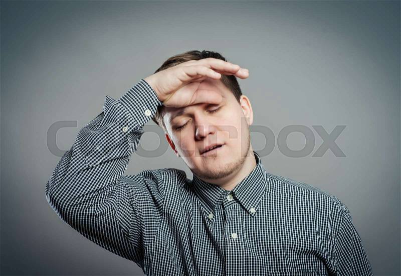 Tired business man rubbing his eyes, stock photo