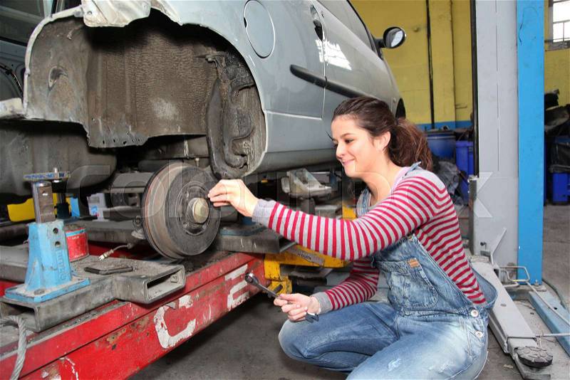 Teenage girl in mechanical professional training, stock photo