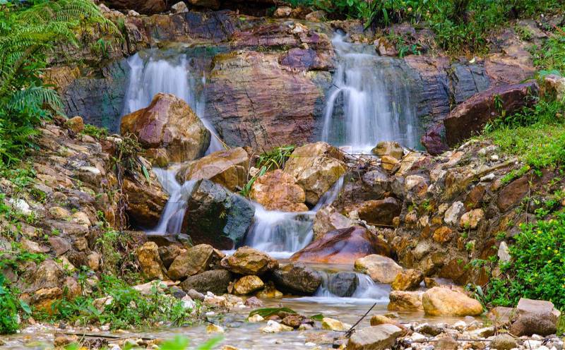 Waterfall in deep rain forest jungle, stock photo
