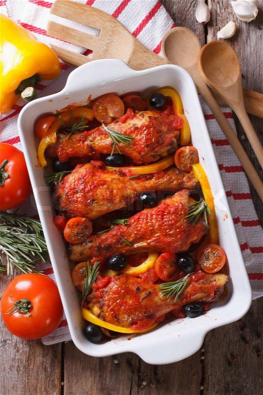 Chicken legs baked in tomato sauce with vegetables. vertical view from above\, stock photo