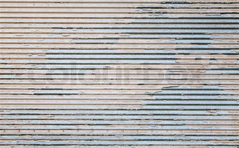 Grungy metal wall with damaged paint layer, background texture, stock photo