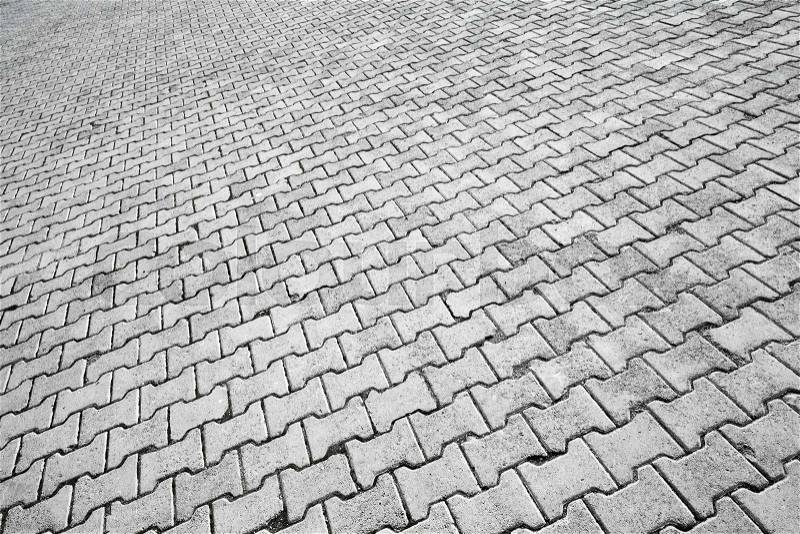 Abstract urban background texture of modern gray cobblestone road pavement, stock photo