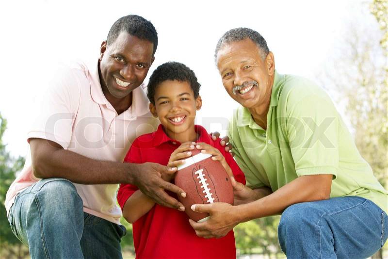 Grandfather With Son And Grandson In Park With American Football, stock photo