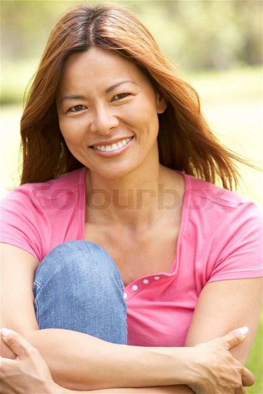 Portrait Of Young Woman In Park, stock photo