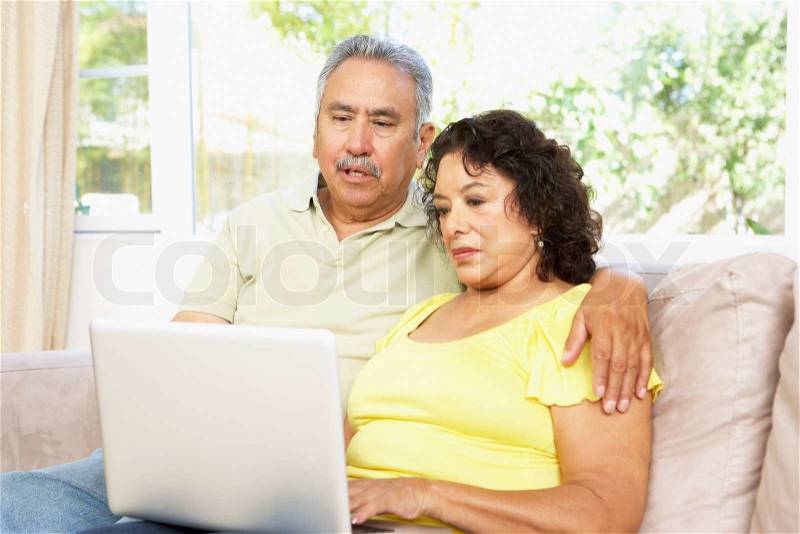 Senior Couple Using Laptop At Home, stock photo