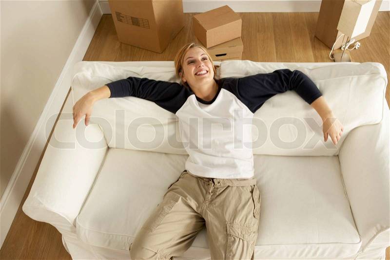 Overhead View Of Young Woman Moving Into New Home, stock photo