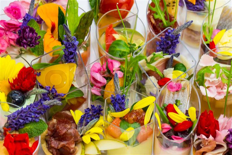 Canaps with edible flowers meat cheese and seafood, stock photo
