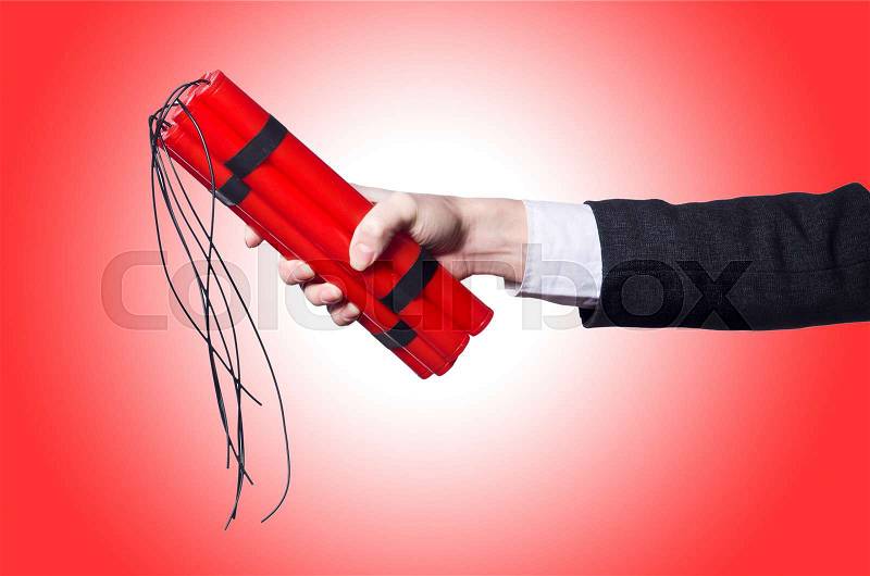 Hand holding bars of dynamite on white, stock photo