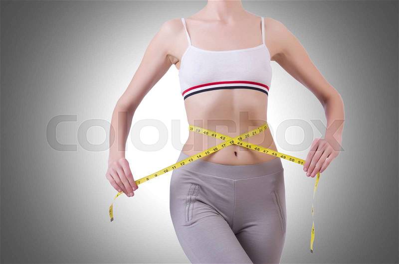 Young girl with centimeter in dieting concept, stock photo