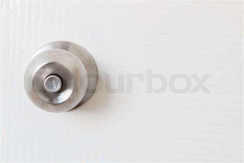 Detail of a metallic knob on white door , tainless steel round ball door knob, stock photo