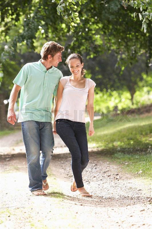 Affectionate Couple Walking In Countryside Together, stock photo