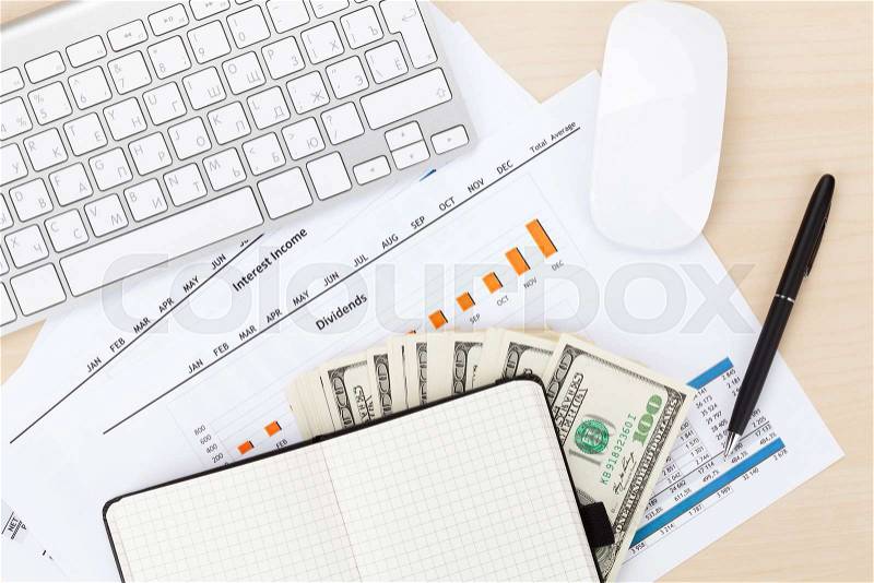 Office table with pc, supplies and money cash. View from above, stock photo