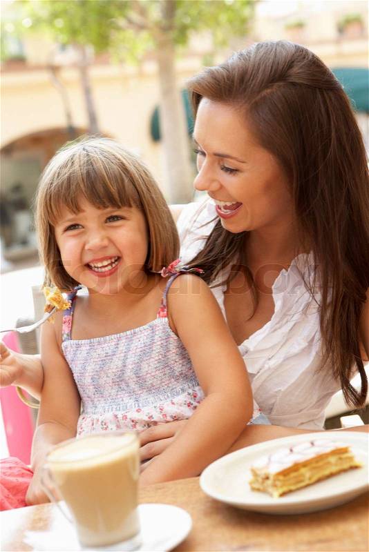 Mother And Daughter Enjoying Cup Of Coffee And Piece Of Cake In Caf?, stock photo