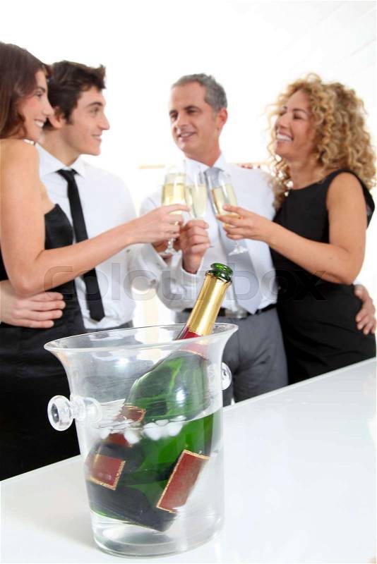 Group of friends cheering with glasses of champagne, stock photo
