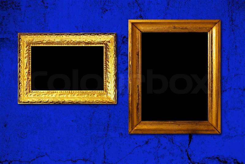 Gold frame on a old blue wall background, stock photo