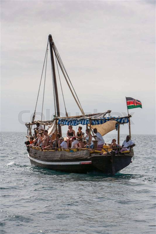 Tourists enjoying sea on yacht. Ship traveling in Kenya, Africa, stock photo