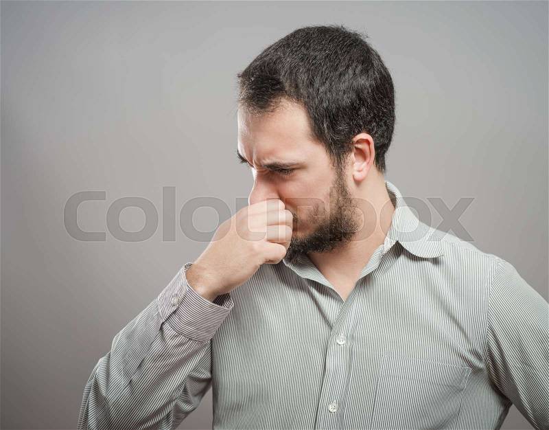 Mature man suffering from sinus pressure pain, stock photo
