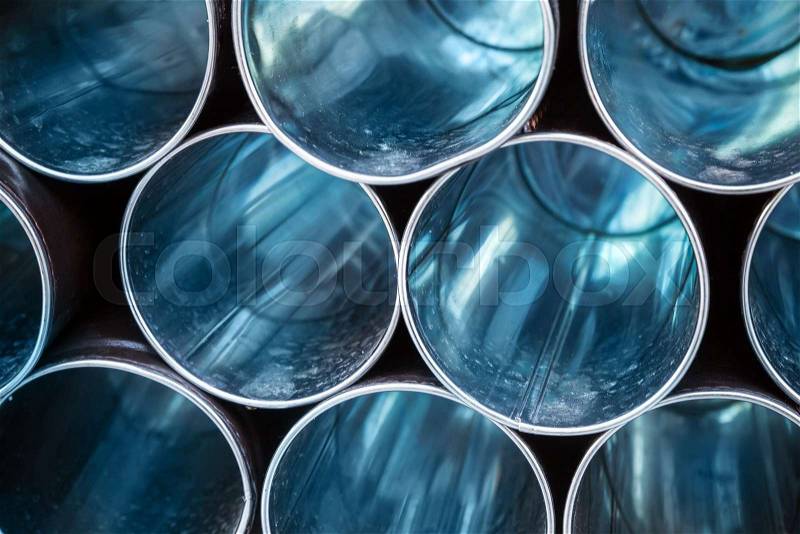 Abstract industrial background, empty blue shining metal tubes, stock photo