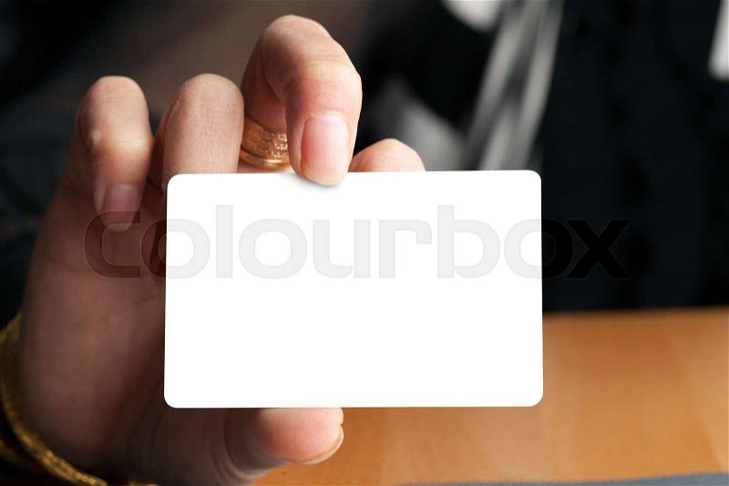 Female hand holding a blank business card gift card or credit card. Plenty of copyspace for your logo or design, stock photo